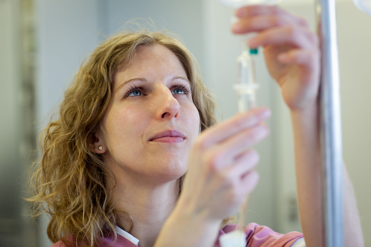 female medical assistant is preparing an infusion